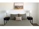 Cozy bedroom with a landscape print above the bed and two lamps on nightstands at 1469 S Boulder St # C, Gilbert, AZ 85296