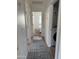 Hallway with wood floors and blue runner leading to a bedroom and laundry closet at 1469 S Boulder St # C, Gilbert, AZ 85296