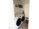 Compact laundry room with white washer and dryer, shelf and ironing board at 1469 S Boulder St # C, Gilbert, AZ 85296