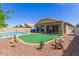 The spacious backyard features a pool, putting green, and covered patio at 1564 E Leaf Rd, San Tan Valley, AZ 85140
