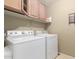 Well-organized laundry room with washer, dryer, and storage cabinets at 1564 E Leaf Rd, San Tan Valley, AZ 85140