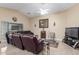 Spacious living room featuring comfortable seating, tile flooring, and natural light at 1564 E Leaf Rd, San Tan Valley, AZ 85140