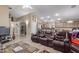 Open living room with tile floors that leads to the kitchen at 1564 E Leaf Rd, San Tan Valley, AZ 85140
