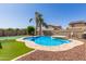 Inviting backyard pool with lush landscaping and clear blue water at 1564 E Leaf Rd, San Tan Valley, AZ 85140