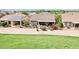 A single-story home features a covered patio, desert landscape, and solar panels in a golf course community at 16077 W Vale Dr, Goodyear, AZ 85395