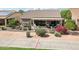 Single-story home boasts a covered patio with desert landscaping and solar panels for energy efficiency at 16077 W Vale Dr, Goodyear, AZ 85395