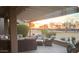 Cozy covered patio with comfortable seating and views of the golf course is perfect for relaxing evenings at 16077 W Vale Dr, Goodyear, AZ 85395