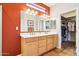 Stylish bathroom featuring double sink vanity and a walk-in closet at 16077 W Vale Dr, Goodyear, AZ 85395