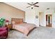 Cozy bedroom features plush carpet, ceiling fan, and comfortable furnishings at 16077 W Vale Dr, Goodyear, AZ 85395