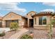 Lovely home with desert landscaping, a three-car garage, and a beautiful tiled roof under a sunny sky at 16077 W Vale Dr, Goodyear, AZ 85395