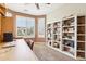 Inviting home office with custom shelving, a ceiling fan and natural lighting at 16077 W Vale Dr, Goodyear, AZ 85395