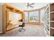 Comfortable home office with custom built-ins and natural lighting at 16077 W Vale Dr, Goodyear, AZ 85395