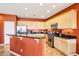 Kitchen featuring stainless steel appliances, including a microwave and gas range at 16077 W Vale Dr, Goodyear, AZ 85395