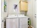 The laundry room has a washer and dryer, plus an overhead cabinet for storage at 16077 W Vale Dr, Goodyear, AZ 85395