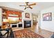 Spacious living room with a modern fireplace, stylish built-in shelving, and large windows for natural light at 16077 W Vale Dr, Goodyear, AZ 85395