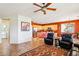 Open-concept living room flows into the kitchen with tile floors, ceiling fan, and a cozy seating area at 16077 W Vale Dr, Goodyear, AZ 85395