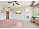 Bright main bedroom boasts a private patio door and a ceiling fan at 16077 W Vale Dr, Goodyear, AZ 85395