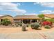 Inviting covered patio with outdoor seating, desert landscaping, offering a comfortable spot to unwind at 16077 W Vale Dr, Goodyear, AZ 85395