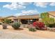 Cozy covered patio with outdoor seating, a TV, and colorful landscaping creates a relaxing outdoor living space at 16077 W Vale Dr, Goodyear, AZ 85395