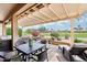 Spacious covered patio with golf course views, perfect for outdoor dining at 16077 W Vale Dr, Goodyear, AZ 85395