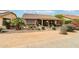 The home's covered patio is ideal for outdoor dining and relaxation, surrounded by desert landscaping at 16077 W Vale Dr, Goodyear, AZ 85395