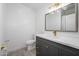 Modern bathroom vanity with marble countertop, gray cabinetry, gold hardware, and stylish light fixture at 17610 N 17Th Pl # 2, Phoenix, AZ 85022