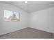 Bright bedroom with a large window and plush carpeting, providing a cozy and inviting atmosphere at 17610 N 17Th Pl # 2, Phoenix, AZ 85022