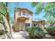 Charming two-story home with desert landscaping and a red tile roof under a clear blue sky at 17610 N 17Th Pl # 2, Phoenix, AZ 85022