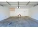 Spacious garage interior with white walls, built-in cabinet, and concrete floor at 17610 N 17Th Pl # 2, Phoenix, AZ 85022