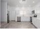Modern kitchen features stainless steel appliances, white cabinets, and quartz countertops at 17610 N 17Th Pl # 2, Phoenix, AZ 85022
