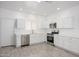 Contemporary kitchen features stainless steel appliances, white cabinets, and bright recessed lighting at 17610 N 17Th Pl # 2, Phoenix, AZ 85022