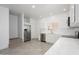 Bright kitchen boasts white cabinets, stainless steel appliances, and seamless transition to living area at 17610 N 17Th Pl # 2, Phoenix, AZ 85022