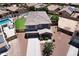 Two-story home boasting a well-manicured lawn, pool, covered porch and mature landscaping in a suburban neighborhood at 18351 W Southgate Ave, Goodyear, AZ 85338