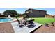 Charming backyard with patio area, pristine artificial grass, and a pool, perfect for relaxation and entertainment at 18351 W Southgate Ave, Goodyear, AZ 85338