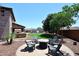 Backyard featuring a fire pit, patio, pool, artificial turf, and barbecue at 18351 W Southgate Ave, Goodyear, AZ 85338