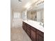 Beautiful bathroom features double sinks, large tub, shower, and plantation shutters at 18351 W Southgate Ave, Goodyear, AZ 85338