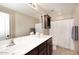 Well-lit bathroom featuring double sinks, vanity, and a shower/tub combination at 18351 W Southgate Ave, Goodyear, AZ 85338