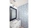 Charming bathroom boasts patterned wallpaper and modern fixtures at 18351 W Southgate Ave, Goodyear, AZ 85338