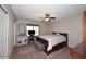 Cozy bedroom featuring a ceiling fan, large window, and stylish zebra-striped bench at 18351 W Southgate Ave, Goodyear, AZ 85338