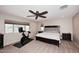 Spacious bedroom with a ceiling fan, large window, and exercise bike at 18351 W Southgate Ave, Goodyear, AZ 85338