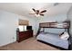 Bright bedroom features a bunk bed, soft carpet, and a ceiling fan at 18351 W Southgate Ave, Goodyear, AZ 85338