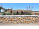 Stone-clad community entrance sign with desert landscaping and clear blue sky at 18351 W Southgate Ave, Goodyear, AZ 85338