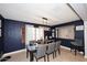 Stylish dining room with a modern chandelier, dark accent wall, and tile flooring at 18351 W Southgate Ave, Goodyear, AZ 85338