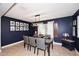 Elegant dining room featuring a dark wood table, gray chairs, and decorative lighting at 18351 W Southgate Ave, Goodyear, AZ 85338