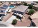 Aerial view of two-story home with tile roof, desert landscaping, long driveway, and a private backyard swimming pool at 18351 W Southgate Ave, Goodyear, AZ 85338