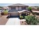 Charming two-story home with stone accents, covered porch, two-car garage, and desert-friendly landscaping at 18351 W Southgate Ave, Goodyear, AZ 85338
