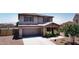 Beautiful two-story home boasting a stone-accented facade, covered porch, and attached two-car garage at 18351 W Southgate Ave, Goodyear, AZ 85338