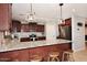 Kitchen boasts granite countertops, stainless steel appliances, and cozy breakfast bar at 18351 W Southgate Ave, Goodyear, AZ 85338
