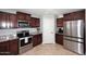 Kitchen featuring stainless steel appliances, granite counters and ample wooden cabinetry at 18351 W Southgate Ave, Goodyear, AZ 85338