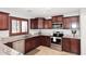 Kitchen featuring stainless steel appliances, granite counters and rich wooden cabinetry at 18351 W Southgate Ave, Goodyear, AZ 85338